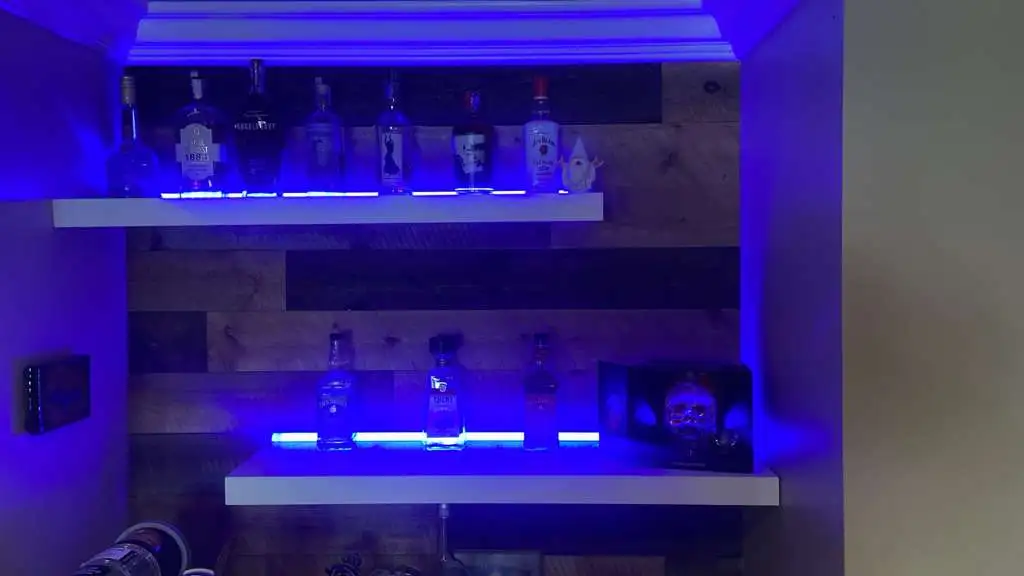 LED accent lighting installed beneath a floating shelf