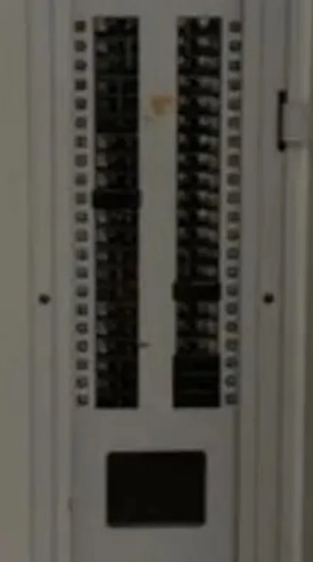 Close-up of breaker rows inside an open electrical panel